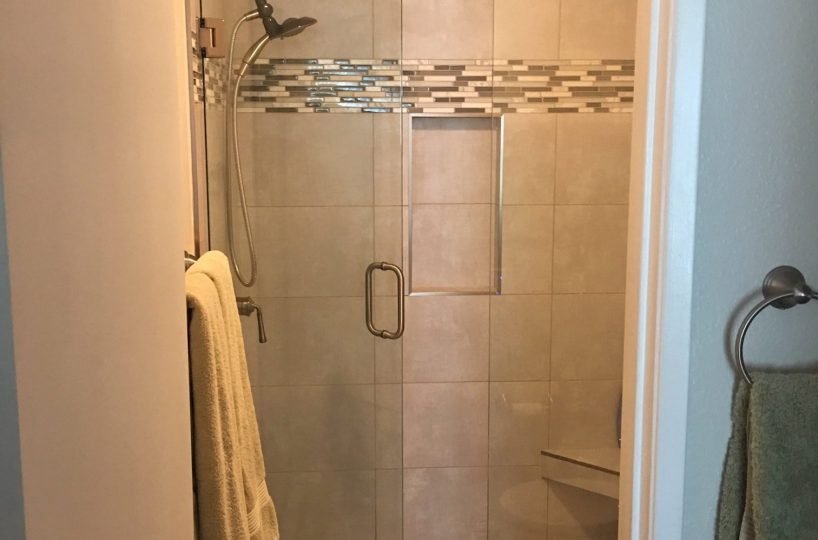 Unit F-106 step in shower with seat and glass door
