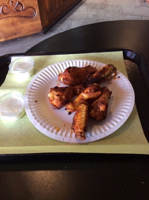 6 Chicken Wings on a paper plate with ranch dipping sauce